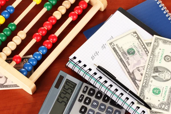 Bright wooden abacus and calculator. Conceptual photo of old and modern business — Stock Photo, Image