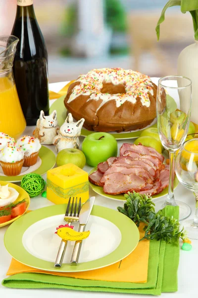 Serving Easter table with tasty dishes on room background — Stock Photo, Image