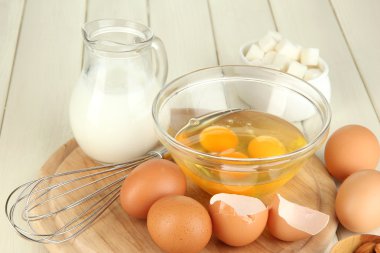 kase ve yanlarında çeşitli malzemeler ahşap masa yakın çekim üzerinde kırık yumurta