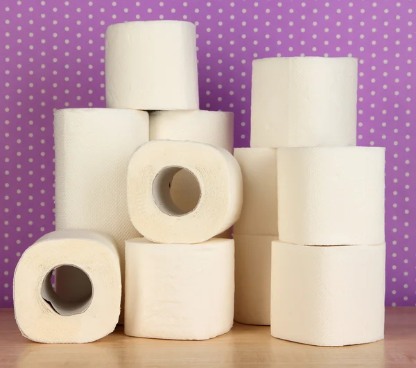 Rolls of toilet paper on purple with dots background — Stok fotoğraf