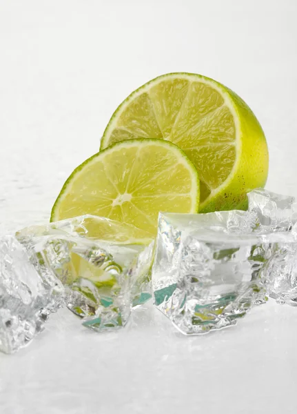 Ice cubes with lime isolated on white — Stock Photo, Image