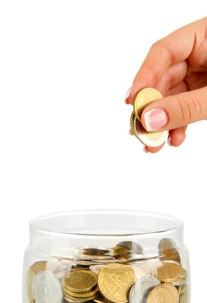 Saving, female hand putting a coin into glass bottle, isolated on white — Stock Photo, Image