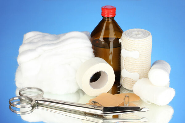 First aid kit for bandaging on blue background