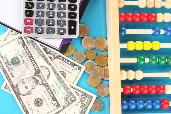 Bright wooden abacus and calculator. Conceptual photo of old and modern business — Stock Photo, Image