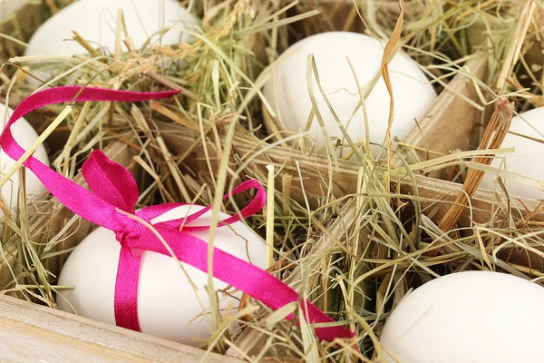 Decorative Easter eggs in wooden basket close up — Stock Photo, Image