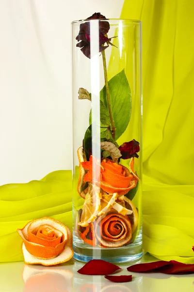 Dried rose in glass vase on white-green fabric background — Stock Photo, Image