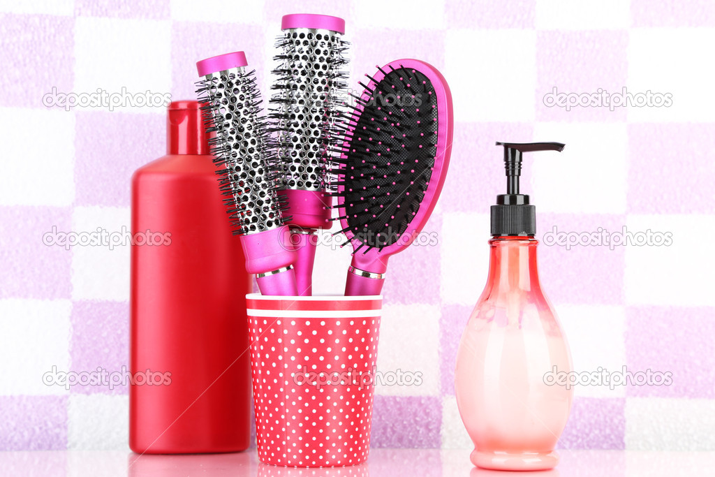 Hair brushes and cosmetic bottles in bathroom