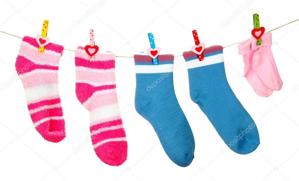 Colorful socks hanging on clothesline, isolated on white