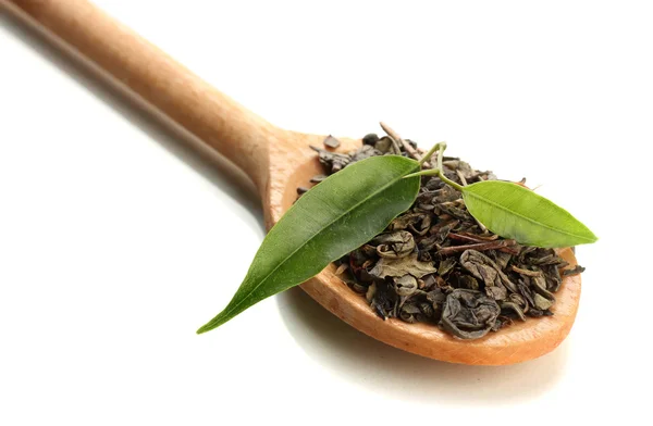 Dry tea with green leaves in wooden spoon, isolated on white — Stock Photo, Image