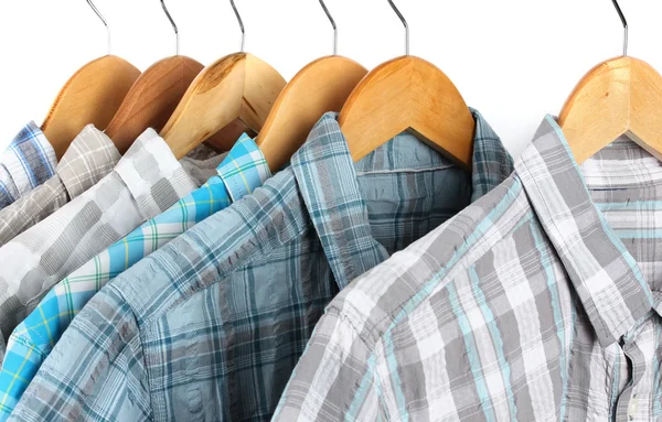 Shirts with ties on wooden hangers isolated on white — Stock Photo, Image