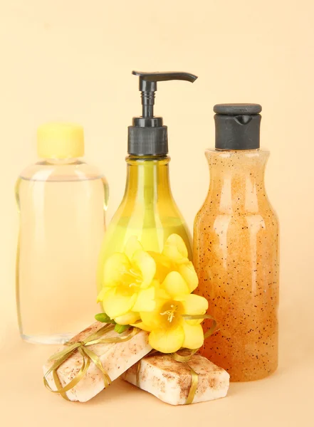 Liquid and hand-made soaps on beige background — Stock Photo, Image