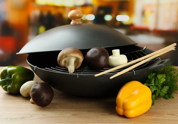 Preto wok pan e legumes na cozinha mesa de madeira, close-up — Fotografia de Stock