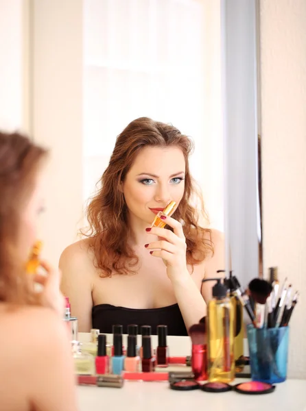 Portrait of attractive woman applying parfume — Stockfoto