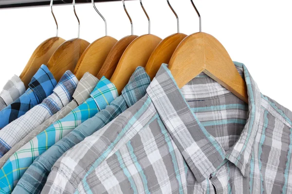 Shirts with ties on wooden hangers isolated on white — Stock Photo, Image