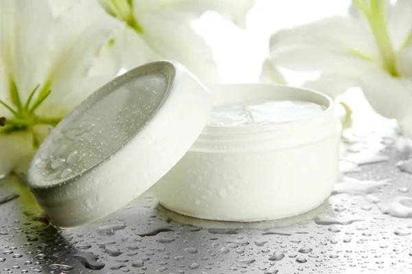 Cosmetic cream and beautiful lily, close up Stock Picture