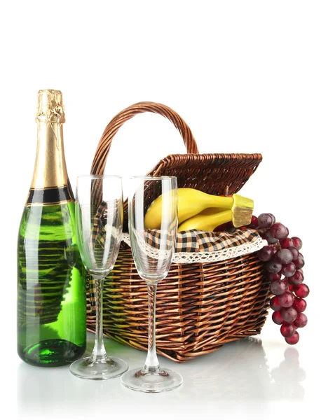 Picnic basket with fruits and bottle of champagne isolated on white — Stock Photo, Image