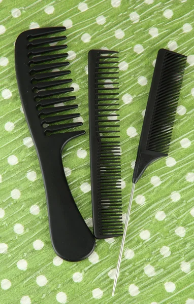 Black combs on color background — Stock Photo, Image