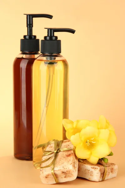 Liquid and hand-made soaps on beige background — Stock Photo, Image