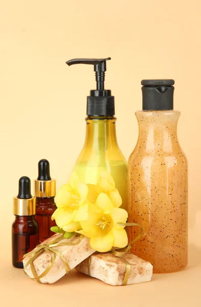 Liquid and hand-made soaps on beige background — Stock Photo, Image