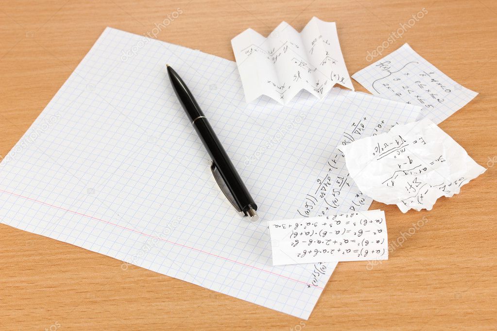 Cheat sheet on wooden table close-up