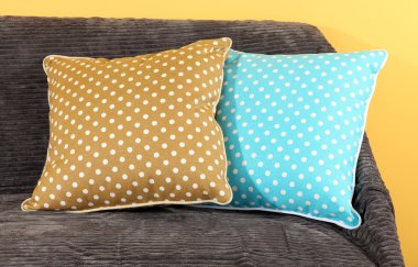 kanepede sarı arka plan üzerinde renkli yastıklar