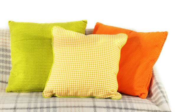 Colorful pillows on couch isolated on white