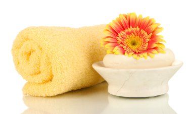 Rolled towel, soap bar and beautiful flower isolated on white clipart