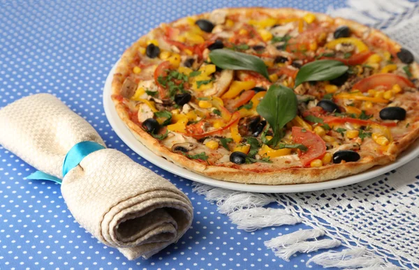 Smakelijke pizza op blauwe tafellaken close-up — Stockfoto
