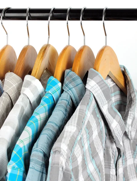 Shirts with ties on wooden hangers isolated on white — Stock Photo, Image