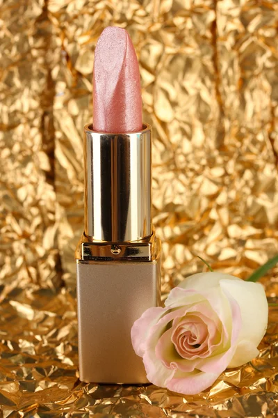 Beautiful lipstick on golden background — Stock Photo, Image