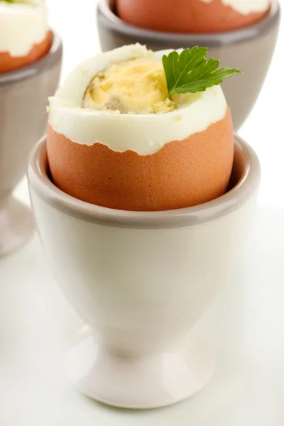 Boiled eggs in egg cup, isolated on white — Stock Photo, Image