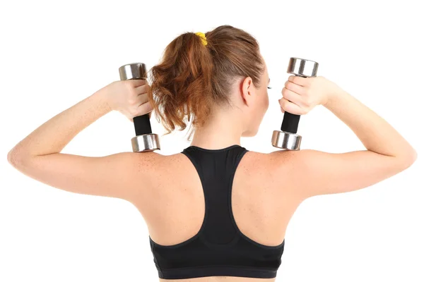 Genç bir kadın fitness egzersizleri üzerinde beyaz izole dumbbell ile yapıyor. — Stok fotoğraf