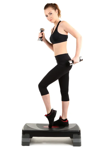 Young woman doing fitness exercises on stepper isolated on white — Stock Photo, Image