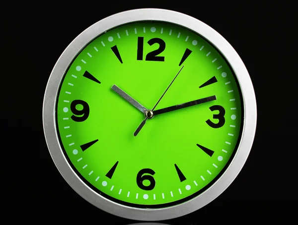 Round office clock on black background — Stock Photo, Image