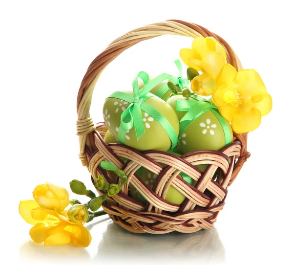 Bright easter eggs with bows in basket, isolated on white — Stock Photo, Image