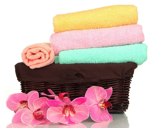 Bathroom towels folded in wicker basket isolated on white — Stock Photo, Image