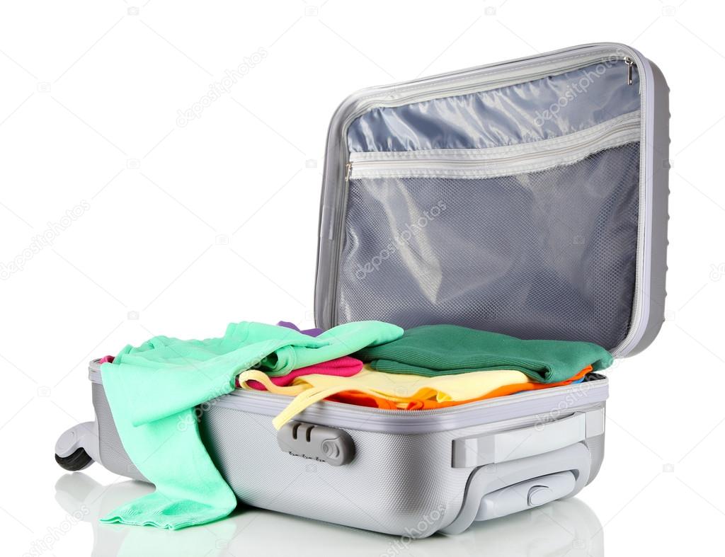 Open silver suitcase with clothing isolated on white