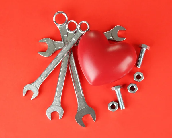 Heart and tools. Concept: Renovation of heart. On color background — Stock Photo, Image