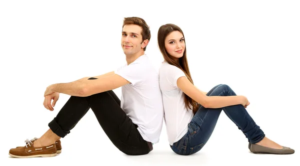 Loving couple sitting with back to each other on floor isolated on white — Stock Photo, Image