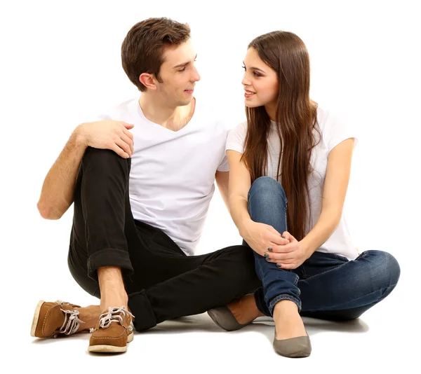 Loving couple sitting with back to each other on floor isolated on white — Stock Photo, Image