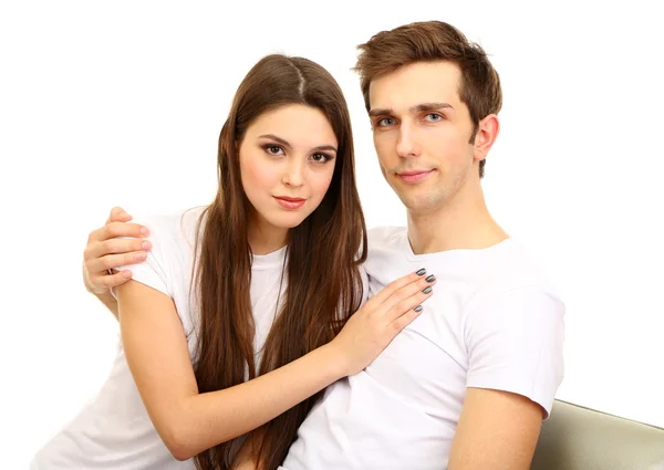 Jovem casal sentado juntos isolado no branco — Fotografia de Stock