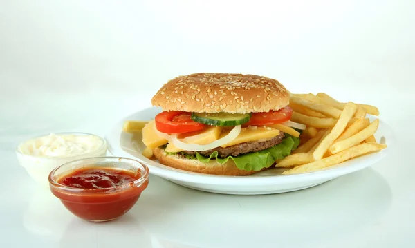 Tasty cheeseburger with fried potatoes, isolated on white — Stock Photo, Image