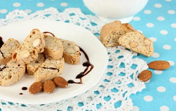 Aromatic cookies cantuccini on plate with cup of coffee on blue tablecloth close-up — Stock Photo, Image