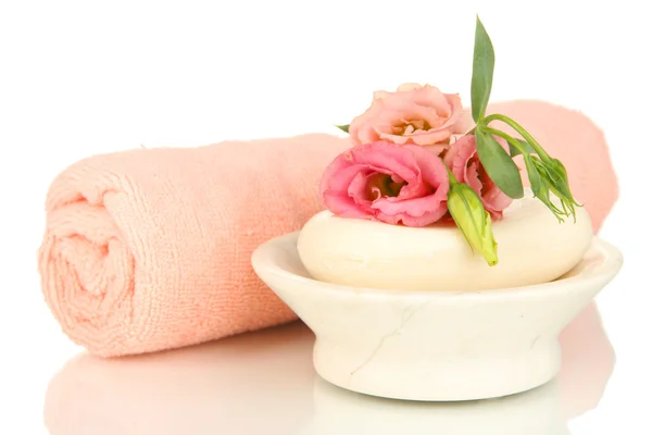 Rolled pink towel, soap bar and beautiful flower isolated on white — Stock Photo, Image