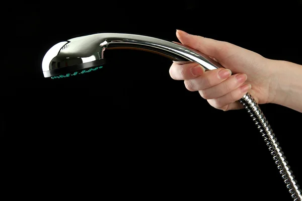 Prysznic w kobiecie rękę na czarnym tle — Zdjęcie stockowe