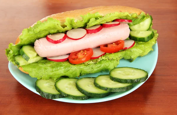 Tasty hot dog on table in cafe — Stock Photo, Image