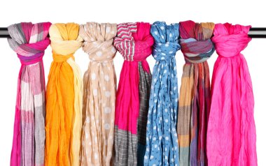 Many bright female scarfs isolated on white clipart