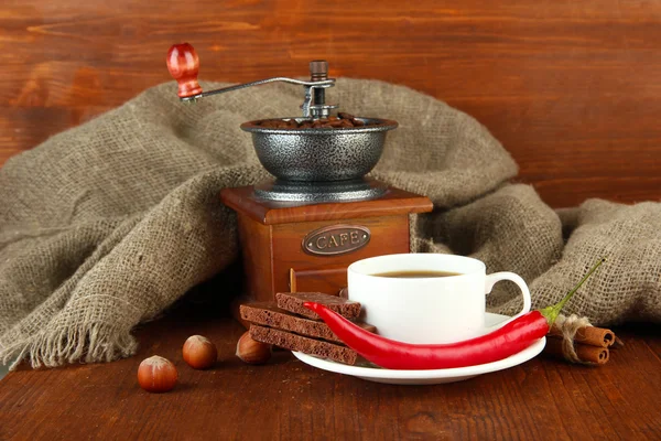 Dark chocolate, hot drink and coffee mill on wooden background — Stock Photo, Image