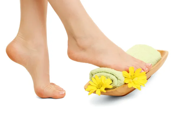 Female feet with towel - spa concept, isolated on white — Stock Photo, Image