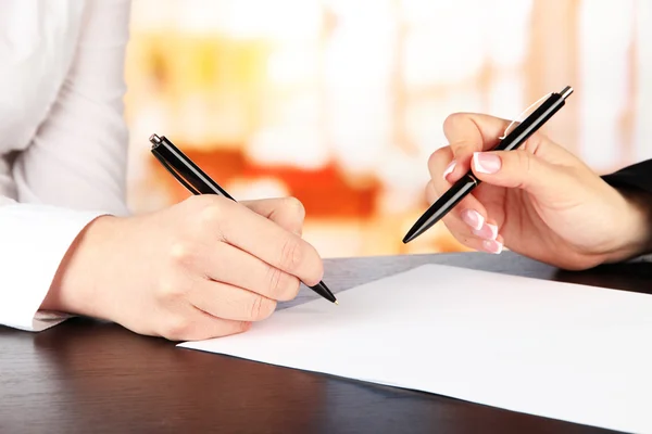 Two business partners signing document, on bright background — Stock Photo, Image